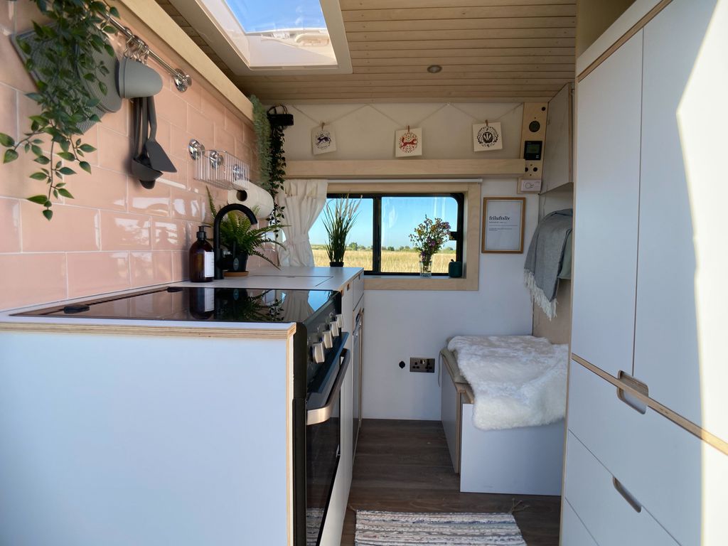 pink kitchen inside a camper van