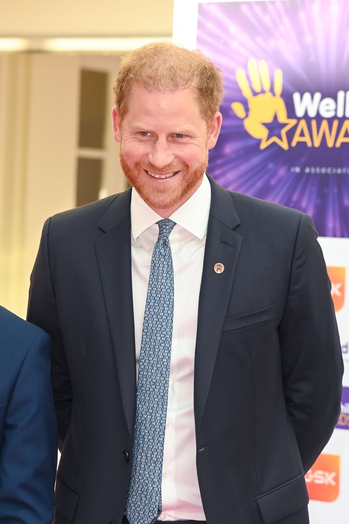 Prince Harry smiling in a suit