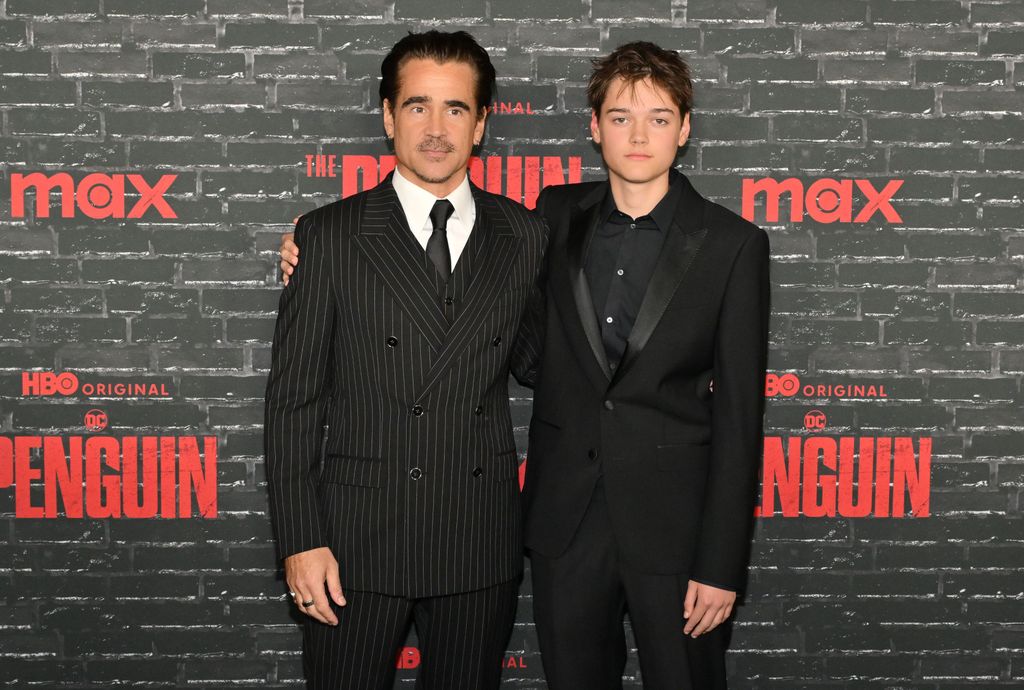 father and son on red carpet in suits 