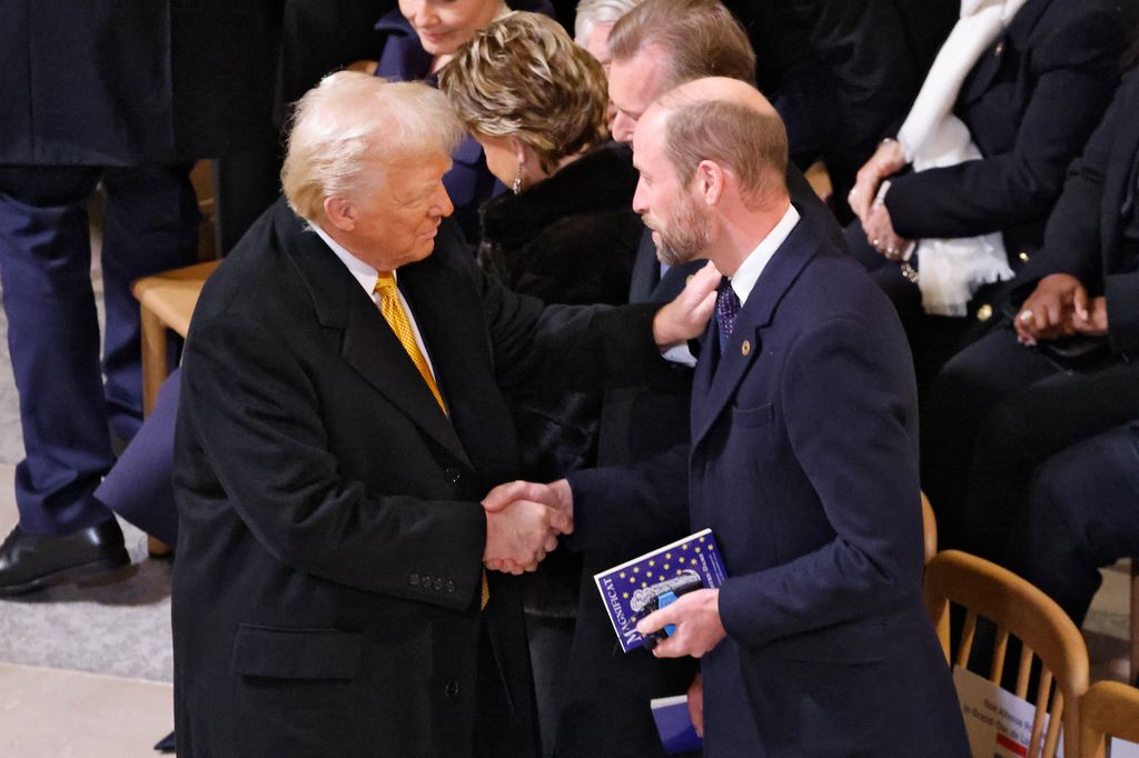 US President-elect Donald Trump (L) shakes hands with Britain's Prince William, Prince of Wales (R) inside Notre-Dame Cathedral