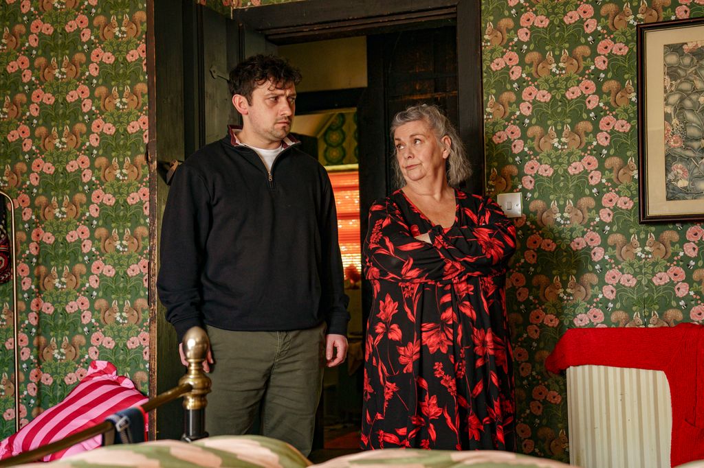 two people standing in bedroom 
