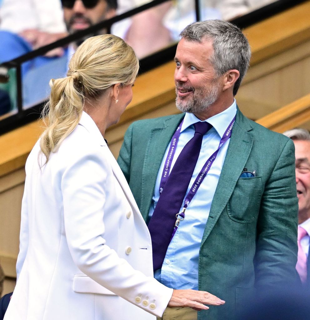 King Frederik reacts as he talks to Duchess Sophie