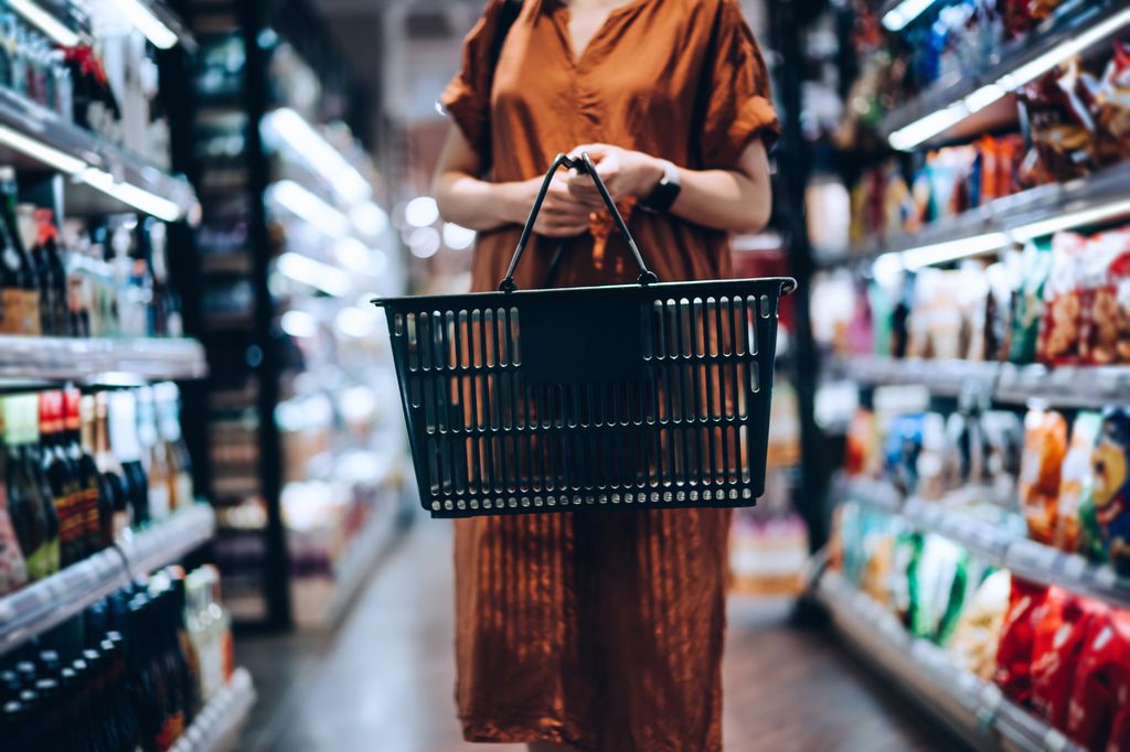 young woman carrying shopping basket