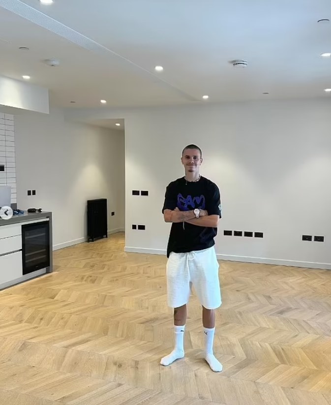 Romeo Beckham standing in an empty room