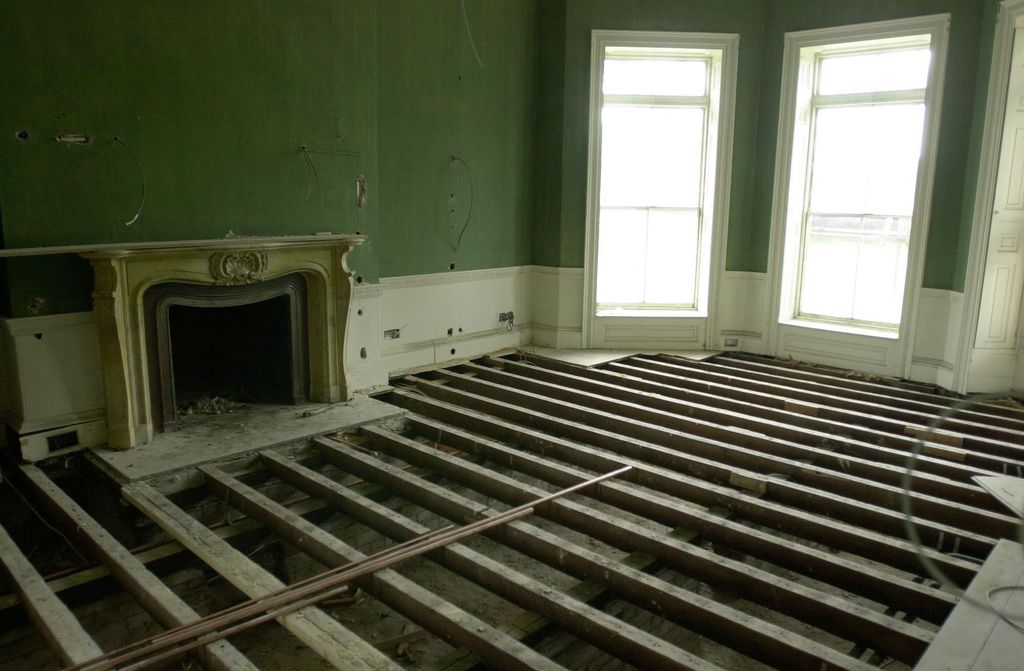 Empty Forest Lodge room with floors missing and green walls