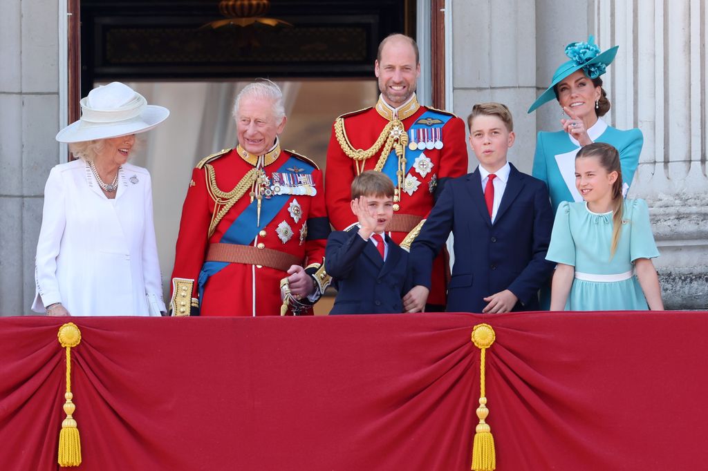 Prince George appears to nudge Louis whilst on the balcony