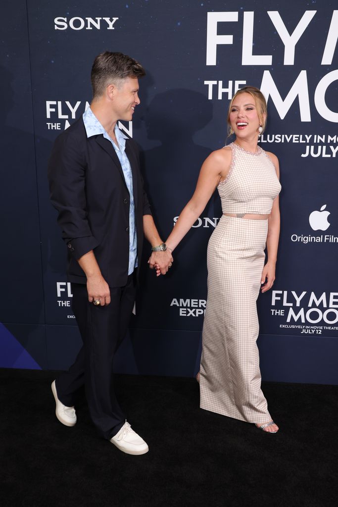 Colin Jost and Scarlett Johansson walk hand in hand at the premiere