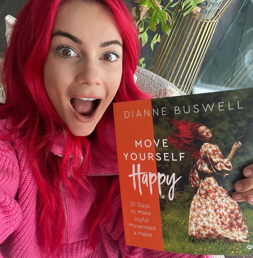 Dianne Buswell holding her wellness book