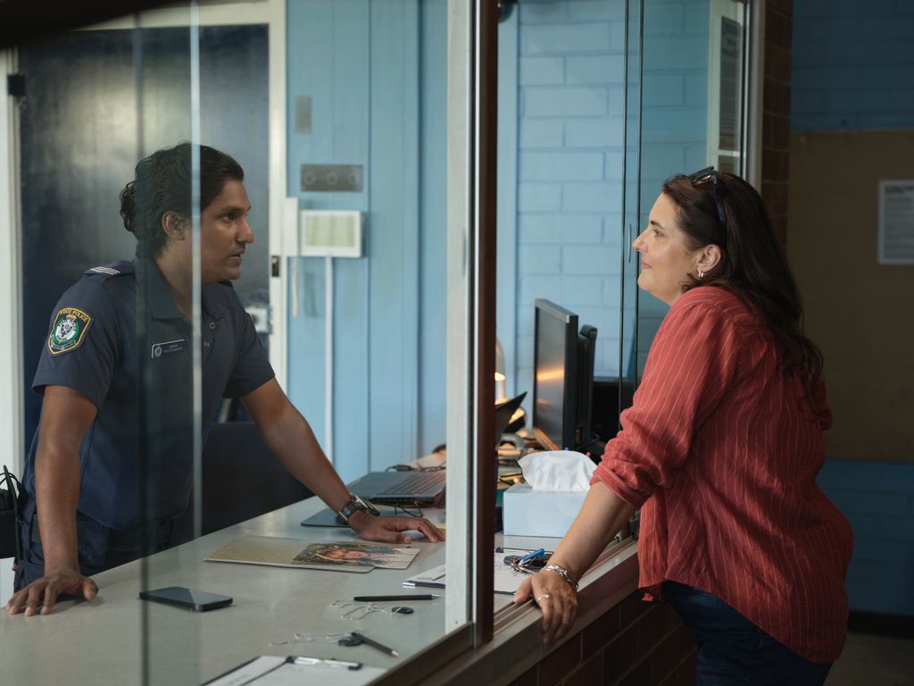 woman standing at reception desk in police station