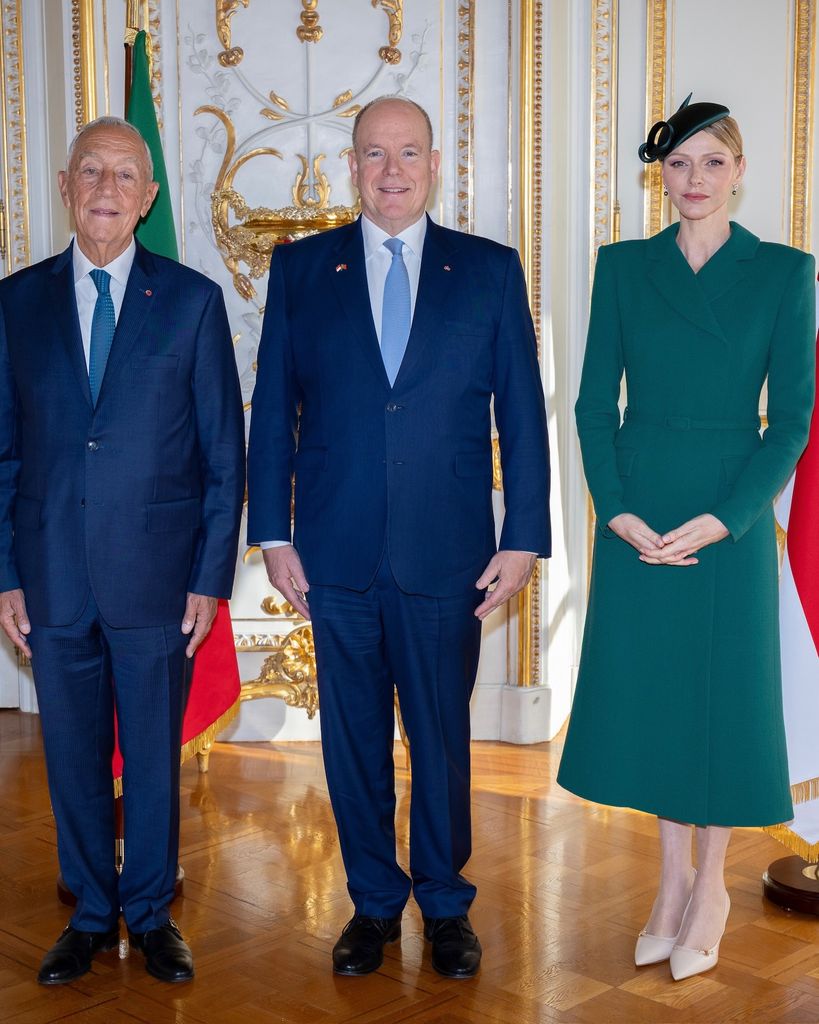 Princess Charlene in green beside prince albert and president of portugal