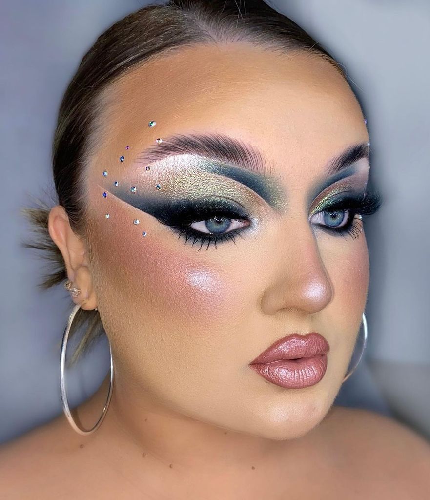 Woman with grey smokey eyeshadow and face gems 