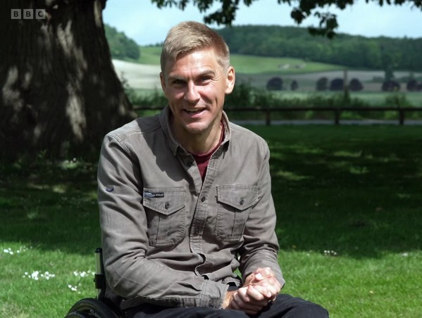 Man sitting in wheelchair in sunny garden