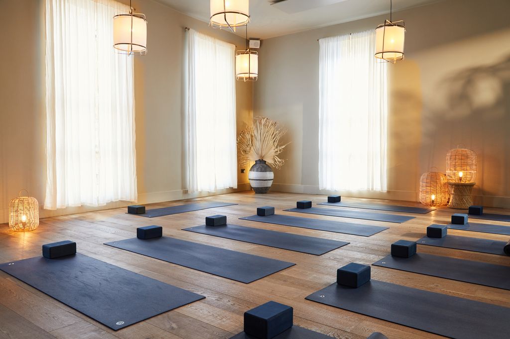Heartcore's studio with yoga mats and warm lighting 