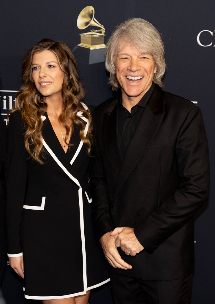 Stephanie Rose Bongiovi  in black blazer dress and Jon Bon Jovi  in suit attend the 66th Grammy Awards Pre-Grammy Gala 
