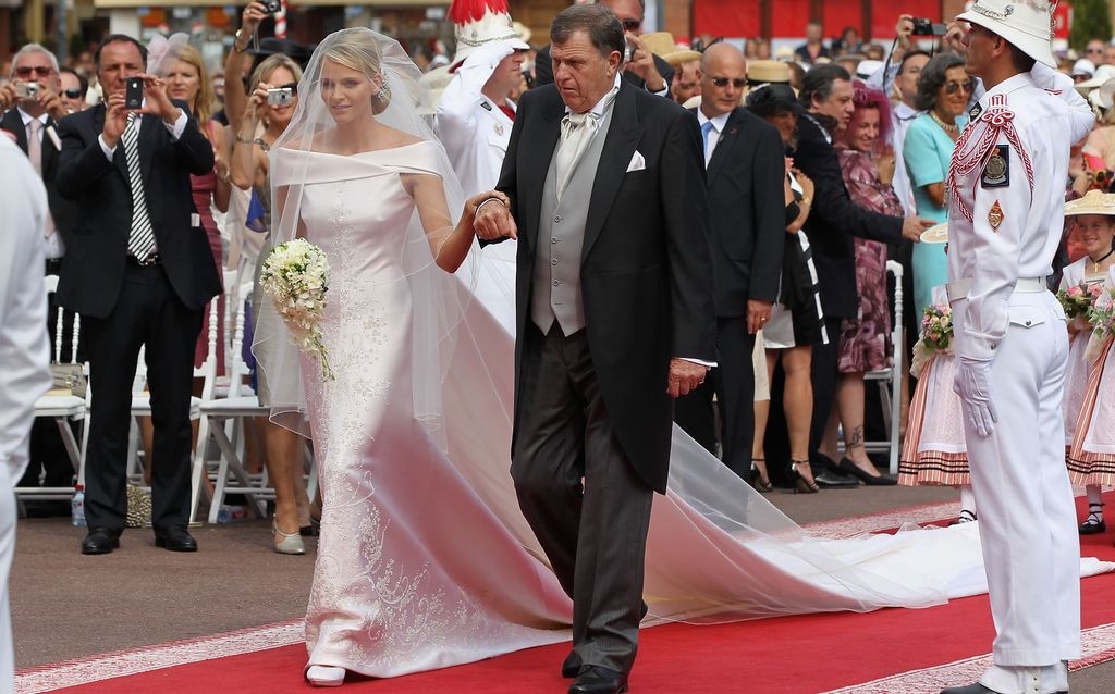 Princess Charlene of Monaco holding hands with Michael Kenneth Wittstock as she walks down the aisle