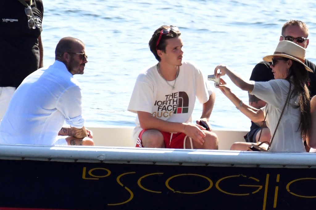 david victoria and cruz beckham on boat in italy 