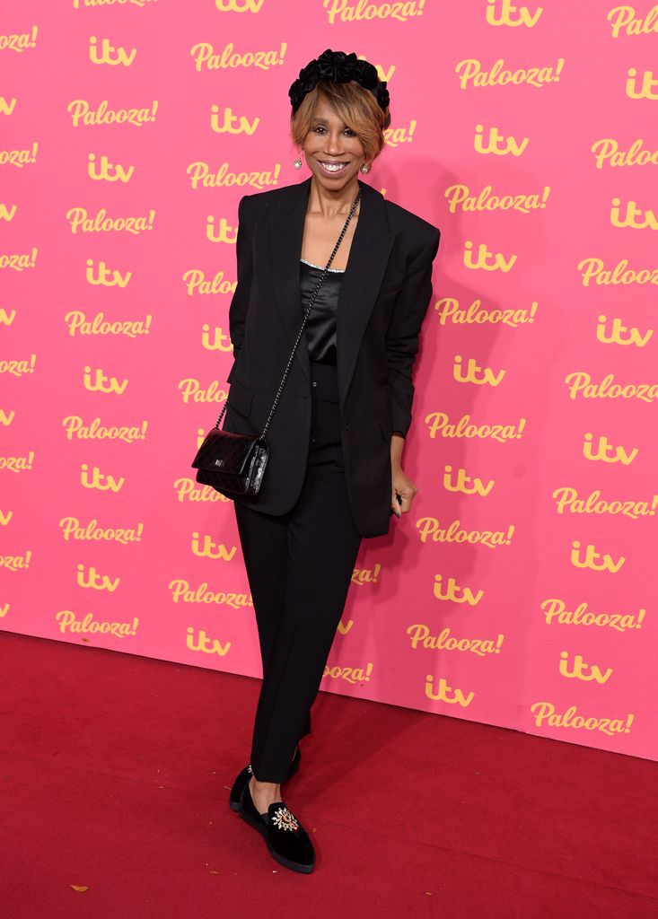 Trisha Goddard in a black suit on the red carpet