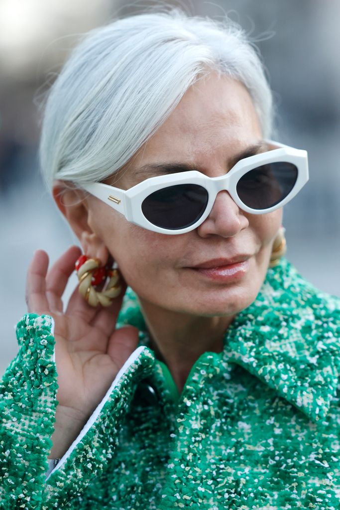 Influencer Grece Ghanem wearing a green jacket by Bottega Veneta, white frame sunglasses by Bottega Veneta, gold and red earrings by Celine, seen during Copenhagen Fashion Week Autumn/Winter 2022 on February 2, 2022 in Copenhagen, Denmark.