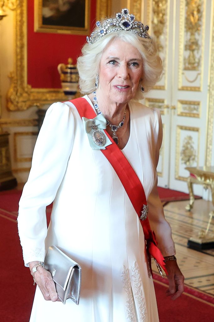 Queen Camilla wearing white dress and sapphire jewels