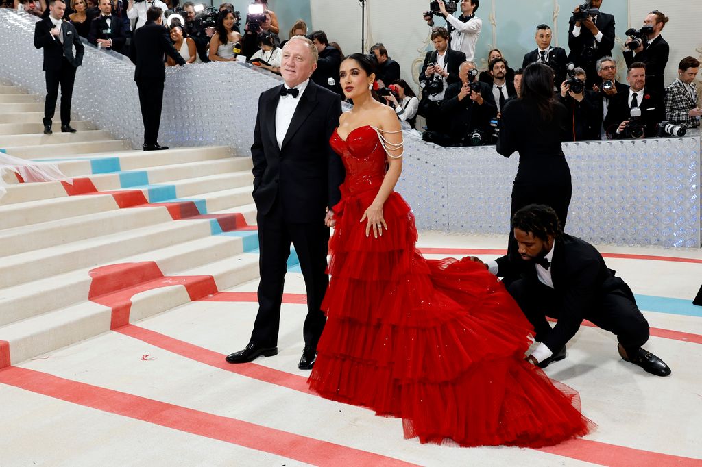 Salma Hayek at the Met Gala 2023 wearing a red tiered gown