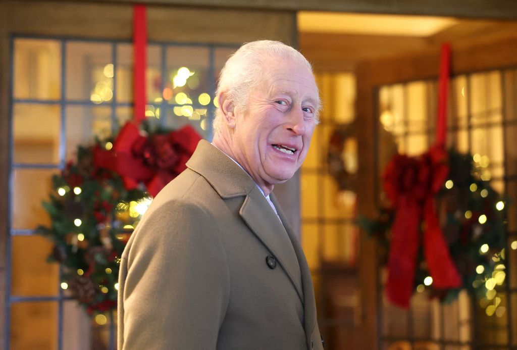 King Charles in front of Christmas wreaths at Highgrove