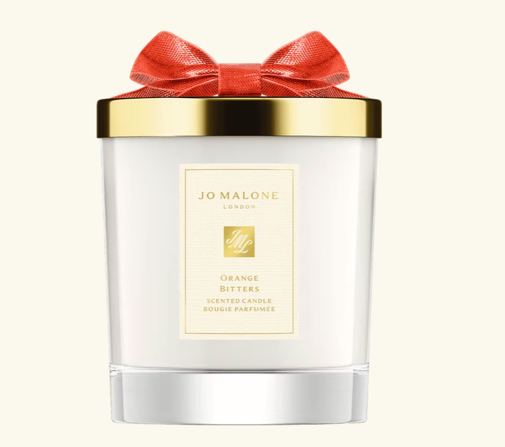 Jo Malone London christmas candle with a red bow on the top and a gold lid