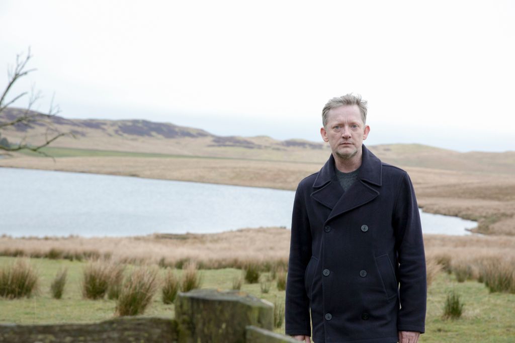 Man standing in front of lake