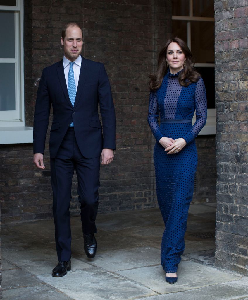 Prince William in suit and Catherine in sheer navy dress