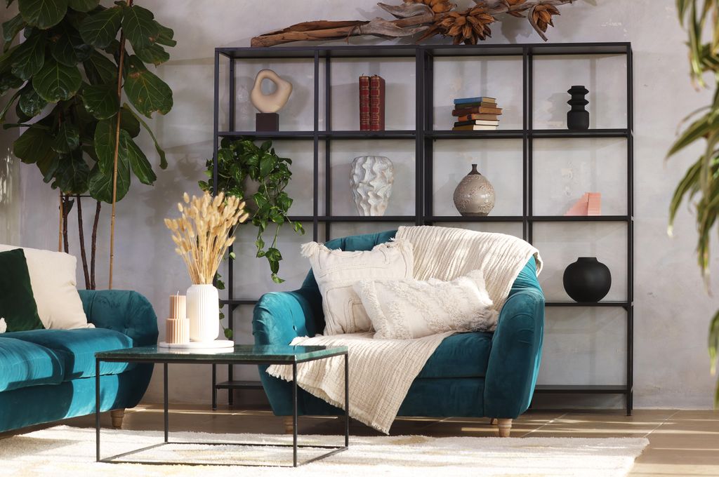 living room with shelving and blue sofa