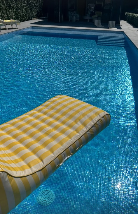 Picture of pool with yellow inflatable lilo floating in the water