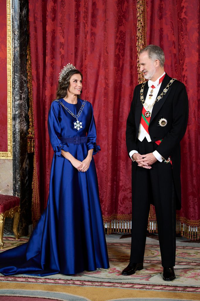 King Felipe VI of Spain and Queen Letizia looking at eachother in formal dress