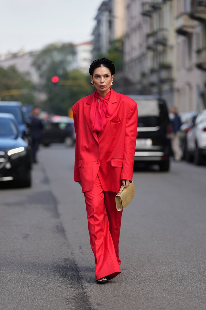 woman on street in red suit