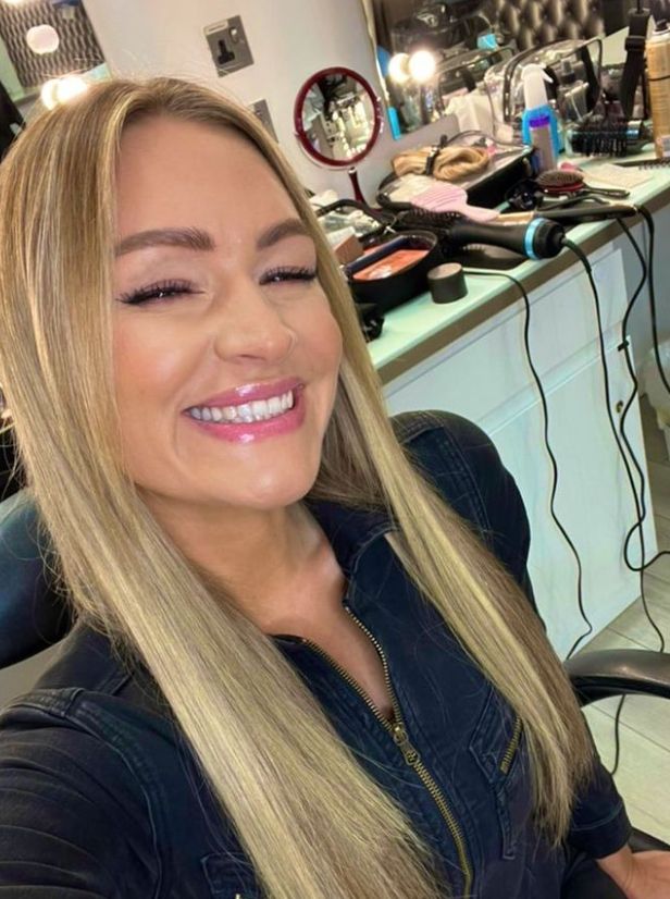 Laura Woods smiling in a makeup studio