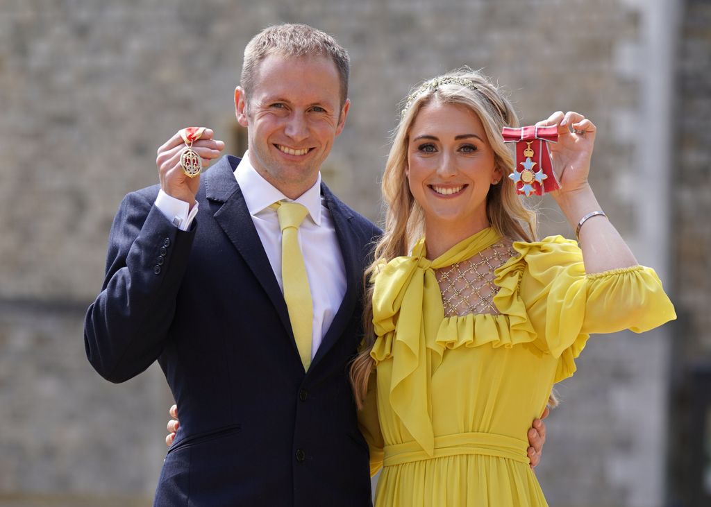 Dame Laura Kenny poses after she received her Dame Commander medal and Sir Jason Kenny poses after he received his Knight Bachelor medal awarded by the Duke of Cambridge during an investiture ceremony at Windsor Castle on May 17, 2022 in Windsor, England