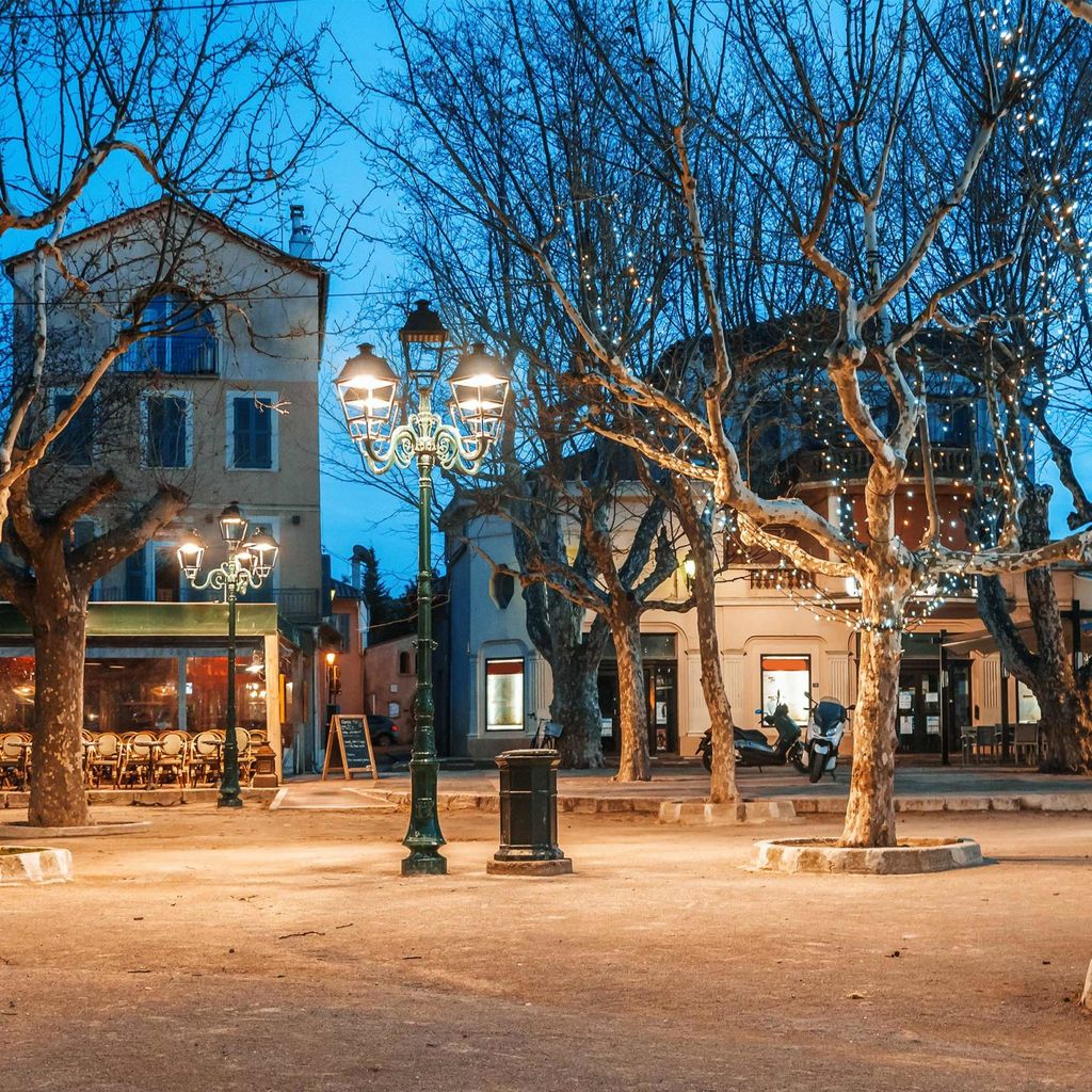 Street view of Nikki Beach St Tropez with fairy lights in trees 