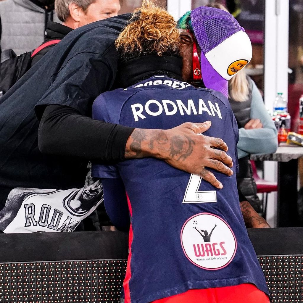 Trinity Rodman hugs her father Dennis in the soccer stands