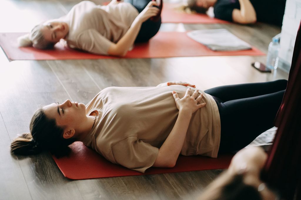 pregnant women in a yoga class with an instructor