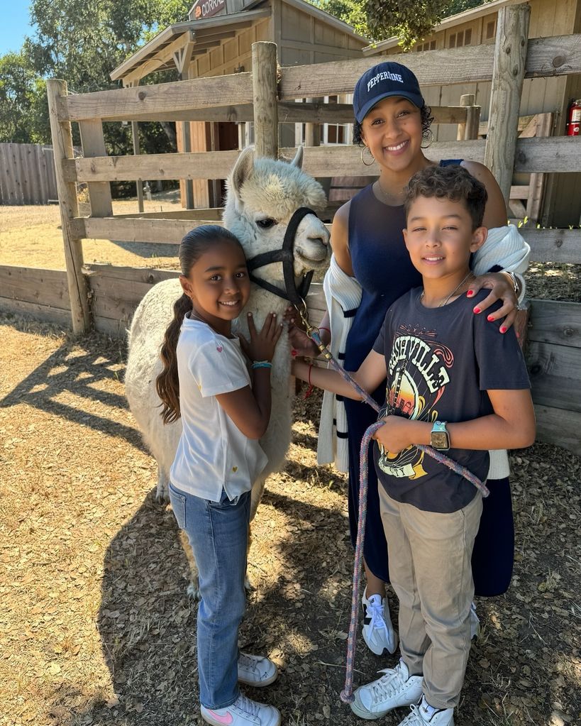 tamera mowry with two kids and alpaca on farm