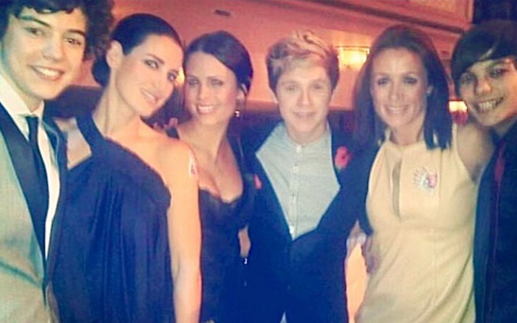 A photo of Natalie Pinkham with members of One Direction