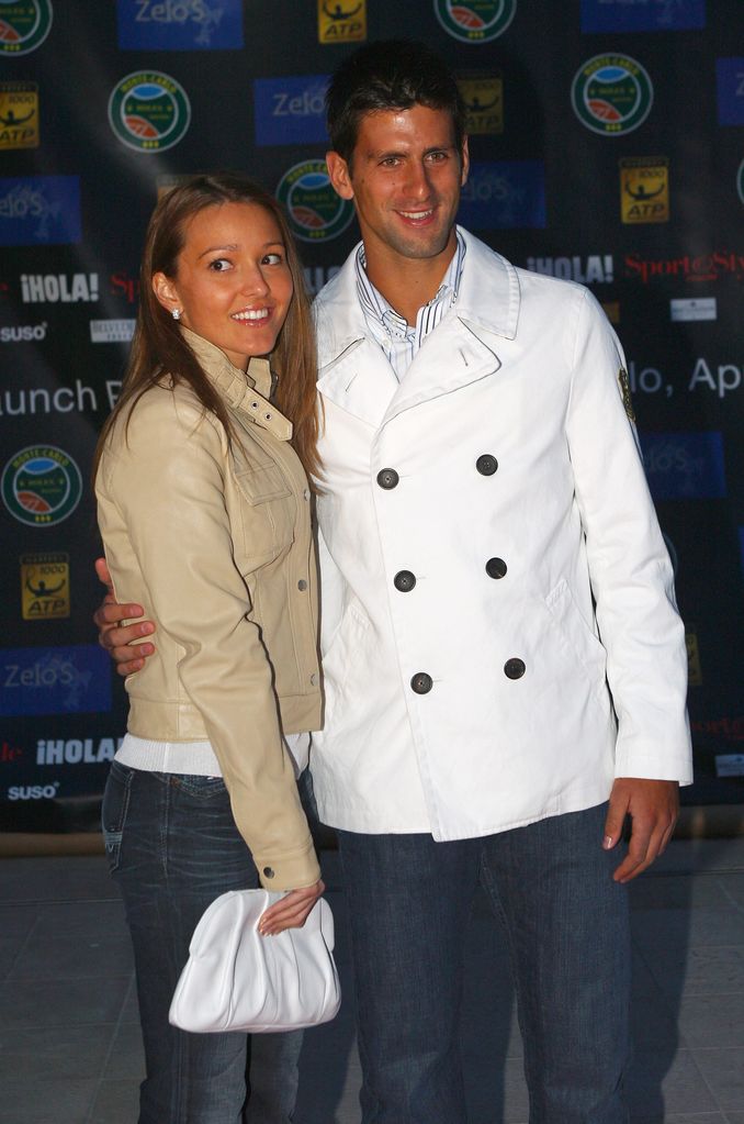 Jelena Djokovic in tan leather coat and jeans with Novak Djokovic in a white jacket and jeans