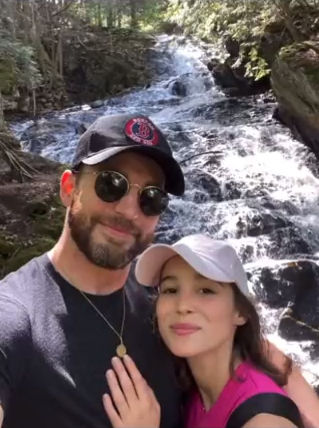 Chris Evans and Alba Baptista pose for a selfie in front of a waterfall