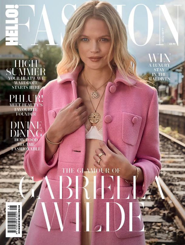 Cover of HELLO! Fashion magazine featuring Gabriella Wilde. She is wearing a pink coat with large buttons and front pockets, layered over a white top or bralette