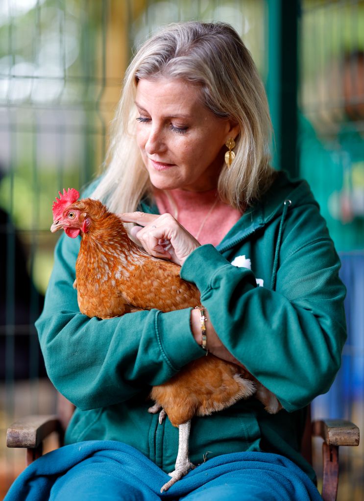 Sophie cuddling rescue chicken Stumpy