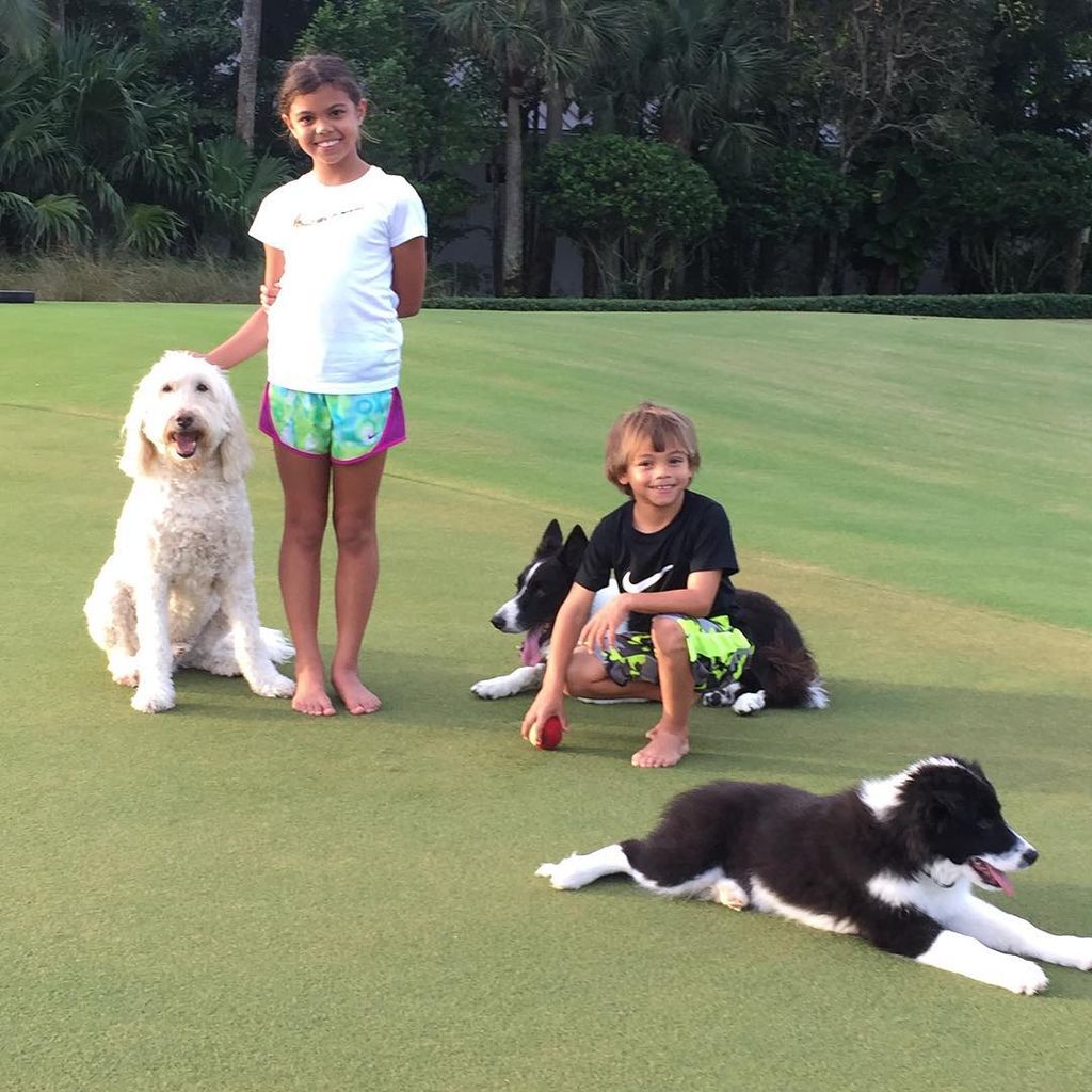 Tiger Woods' son and daughter with their dogs in the garden
