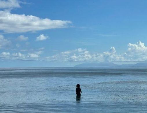 Faraway shot of Cressida Bonas in the sea