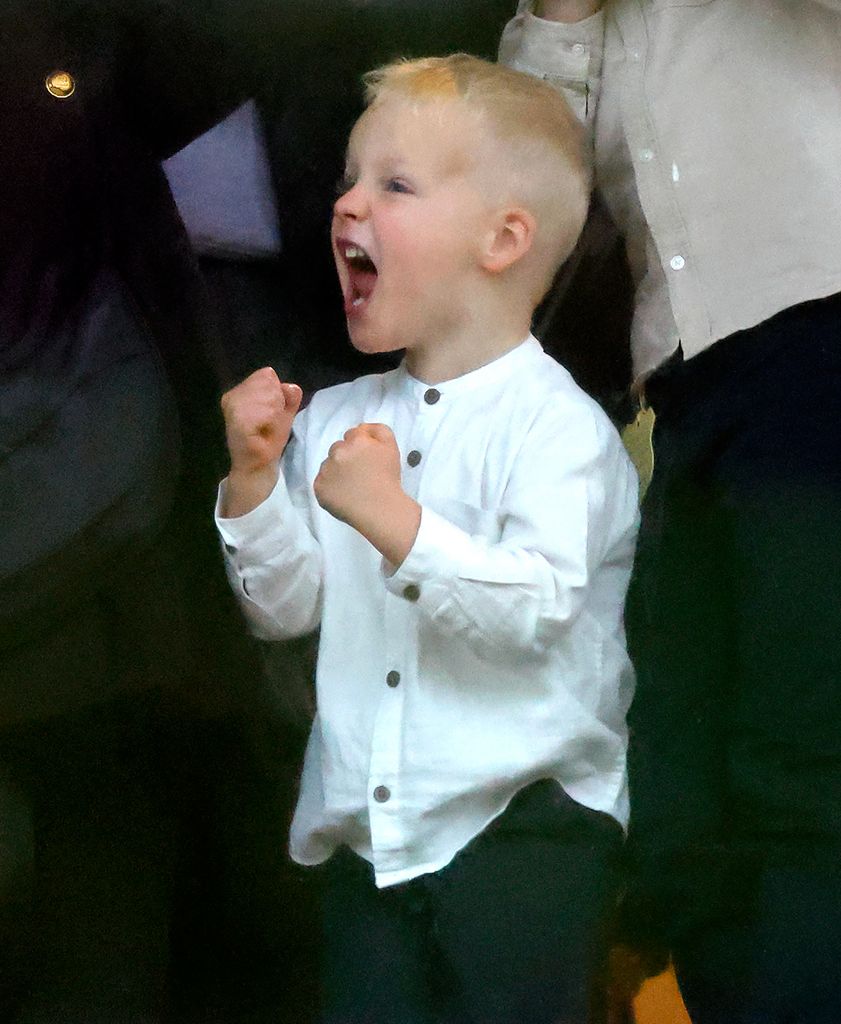 young boy celebrating in white shirt