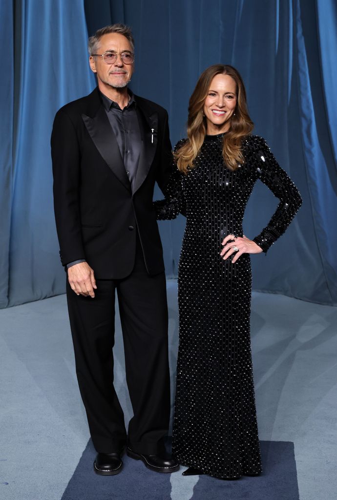 Robert Downey Jr. and Susan Downey both wearing black posing together