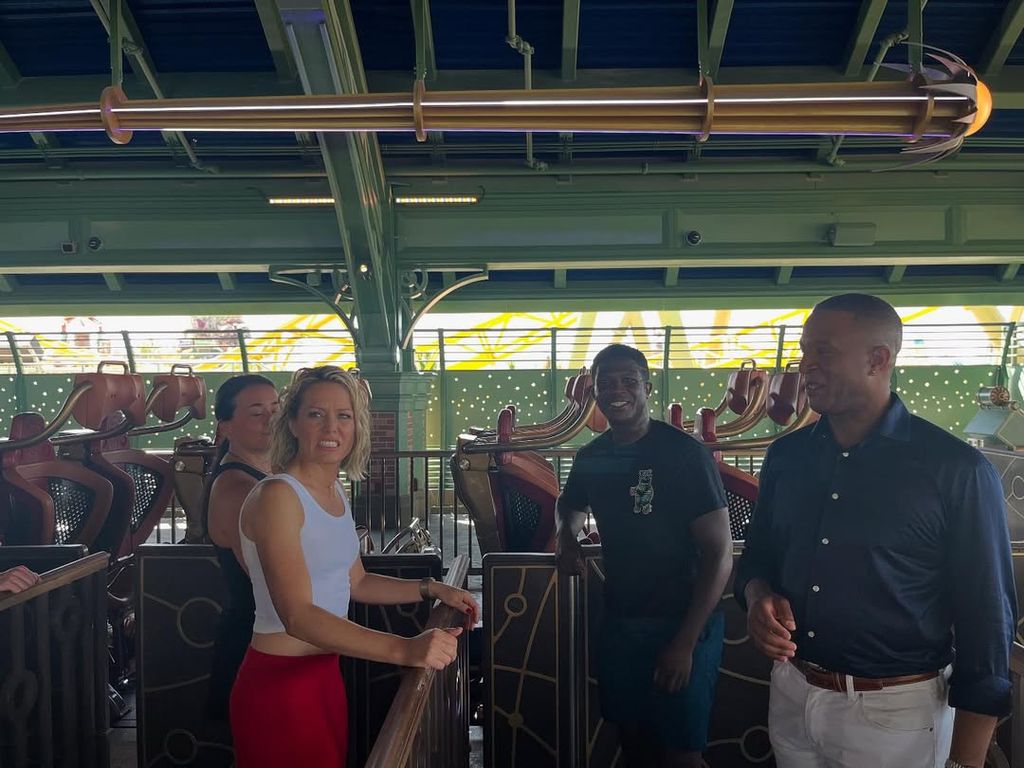 Dylan looks concerned ready to board rollercoaster with Craig Melvin