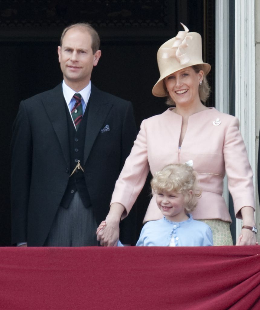 Lady Louise smiling on balcony with Edward and Sophie