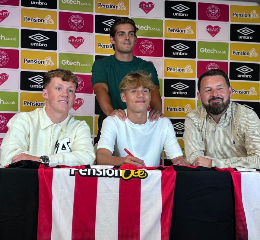 Beau Redknapp signing a contract with Charley Redknapp behind him